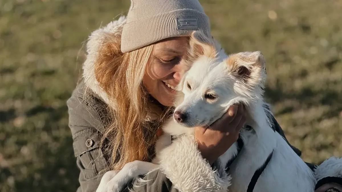Dog owner comforting dog home